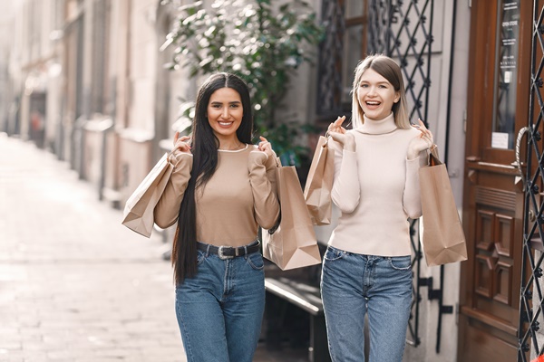 1-happy-young-women-with-shopping-bags-walking-on-street