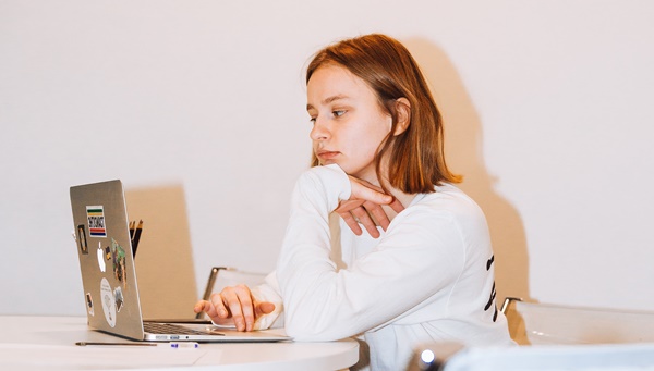 1-woman-in-white-long-sleeve-top-sitting-on-chair