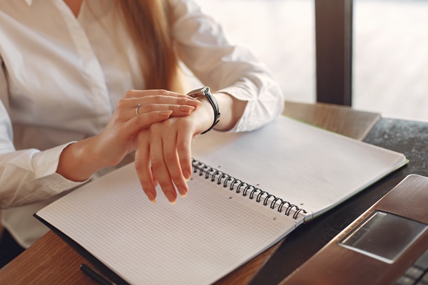 31-faceless-crop-female-entrepreneur-checking-time-while-3873853