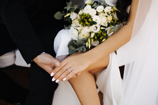 50-woman-in-white-dress-holding-white-flowers