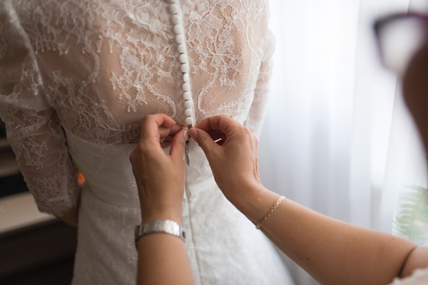 person-fixing-dress-on-girl-1676133