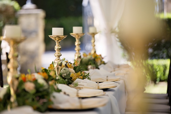 selective-focus-of-candlesticks-on-table-with-wedding-set-up-1128783