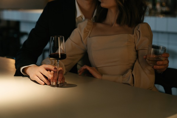 woman-in-beige-long-sleeve-shirt-holding-wine-glass-4695783