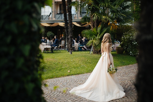 woman-wearing-wedding-dress-and-holding-a-bouquet-of-flowers-2472858